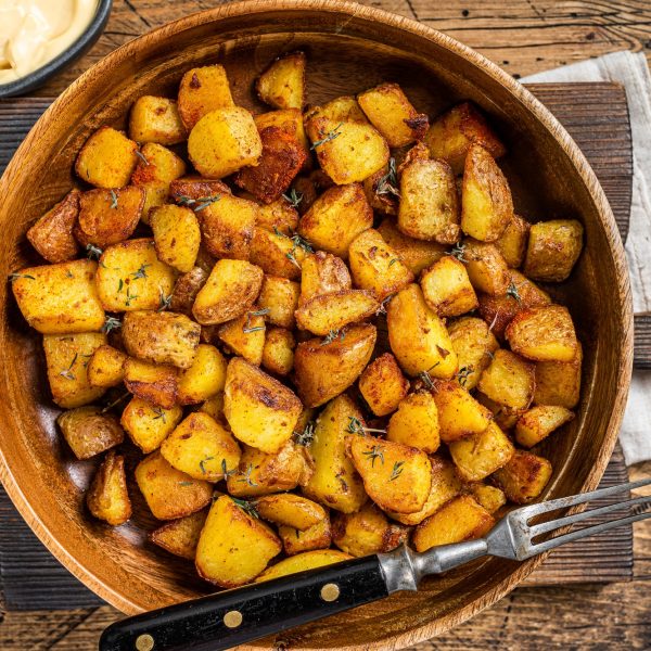 Fried potato - Patatas bravas traditional Spanish potatoes snack tapas. wooden background. Top view