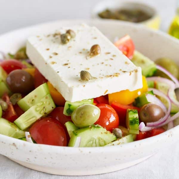 Greek village salad horiatiki with feta cheese, side view, close up