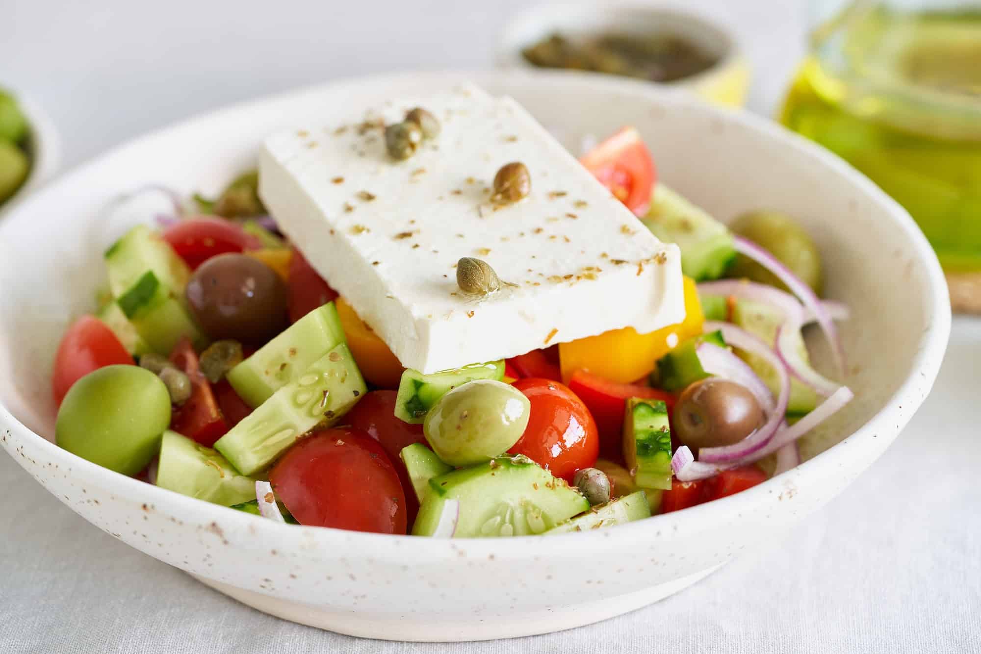 Greek village salad horiatiki with feta cheese, side view, close up