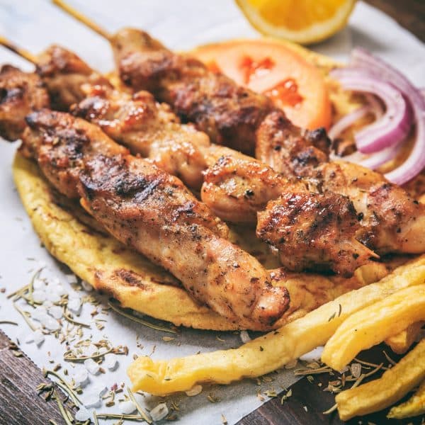 Meat skewers on a wooden background